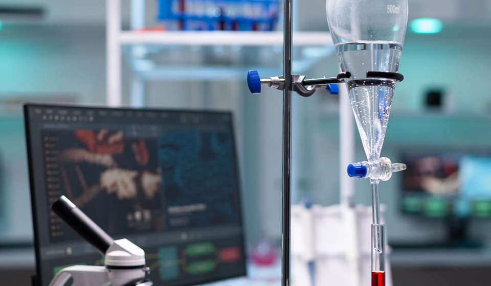 Science laboratory equipment and test tube with blood for healthcare development. Chemical dripping pipe with glass flask for analysis in biochemistry lab at clinic. Professional instruments